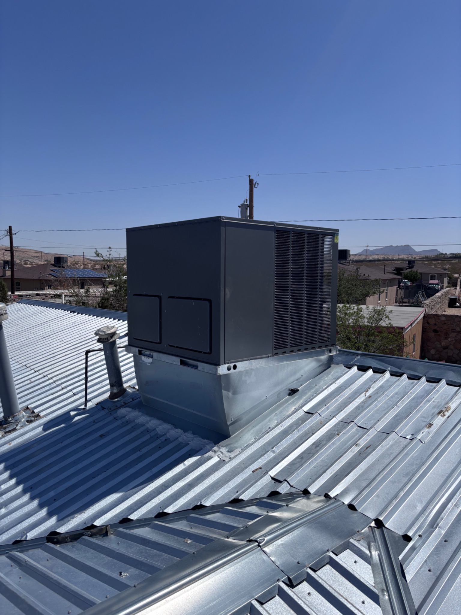 Rooftop package HVAC unit on metal roof